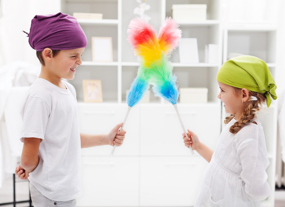 One for all and all for a tidy room One for all and all for a tidy room - kids with duster brushes, focus on the girl