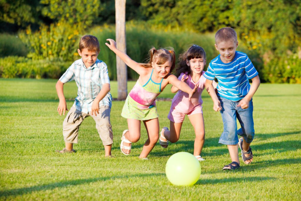Boys and girls running towards ball